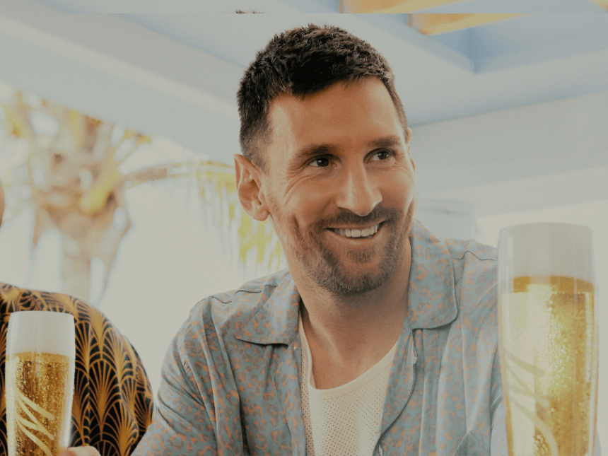 Lionel Messi standing at a bar