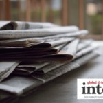 A pile of newspapers on a table