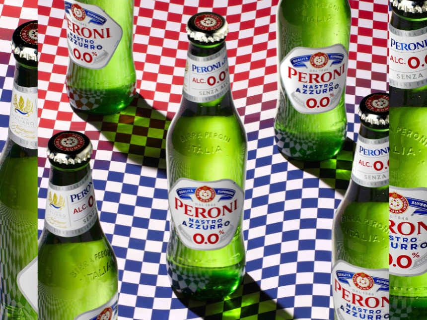 Bottles of Peroni Nastro Azzurro 0.0% against a chequered flag backdrop