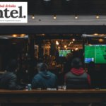 View into an on-premise venue showing sport on a television