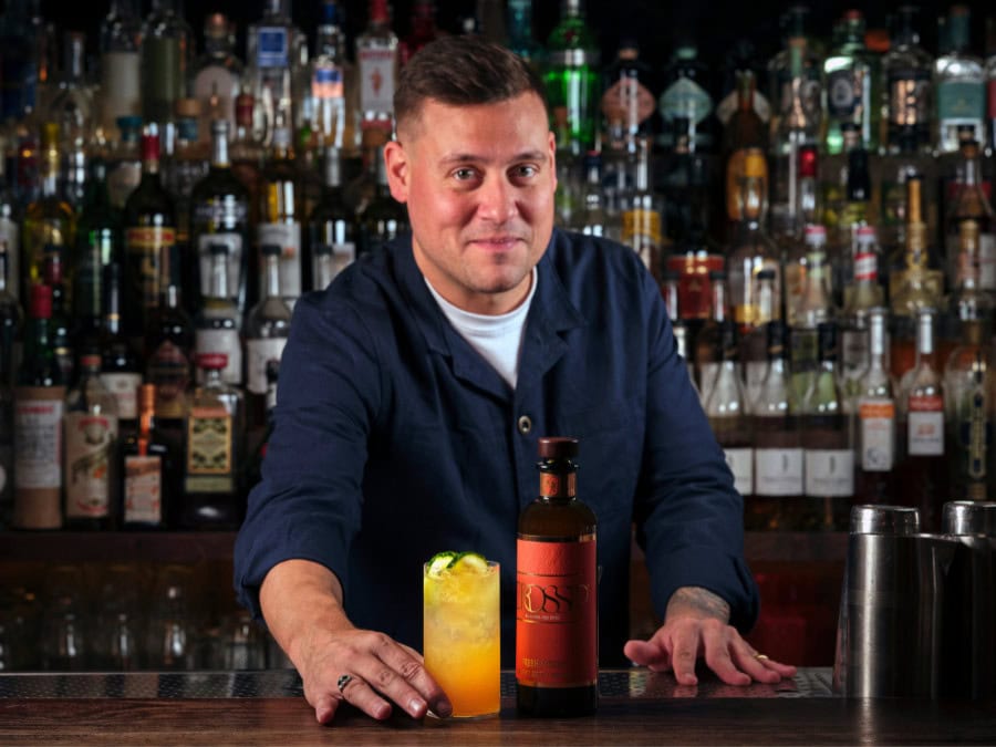 Bartender serving a cocktail made with Crossip