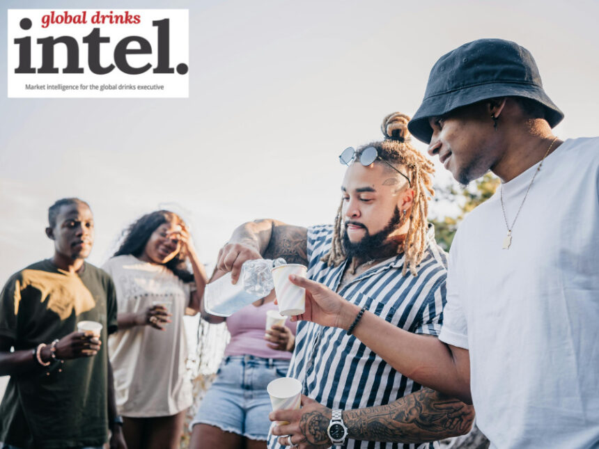 Adults sharing drinks outdoors