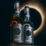 Bottle of Total Eclipse Bourbon next to Total Eclipse Moonshine