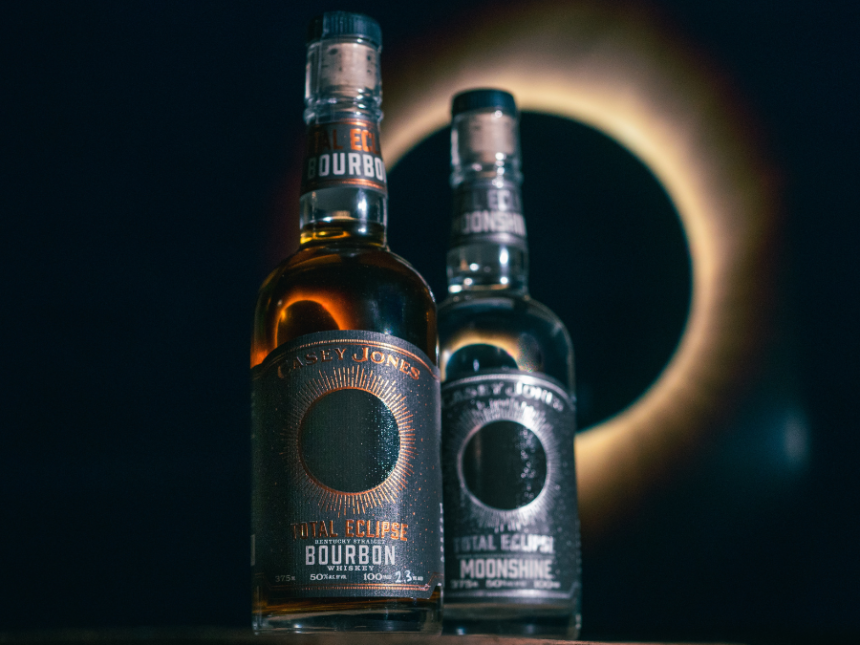 Bottle of Total Eclipse Bourbon next to Total Eclipse Moonshine