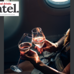 Two glasses of champagne up-close on an aeroplane with Global Drinks Intel logo