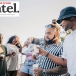 Adults sharing drinks outdoors