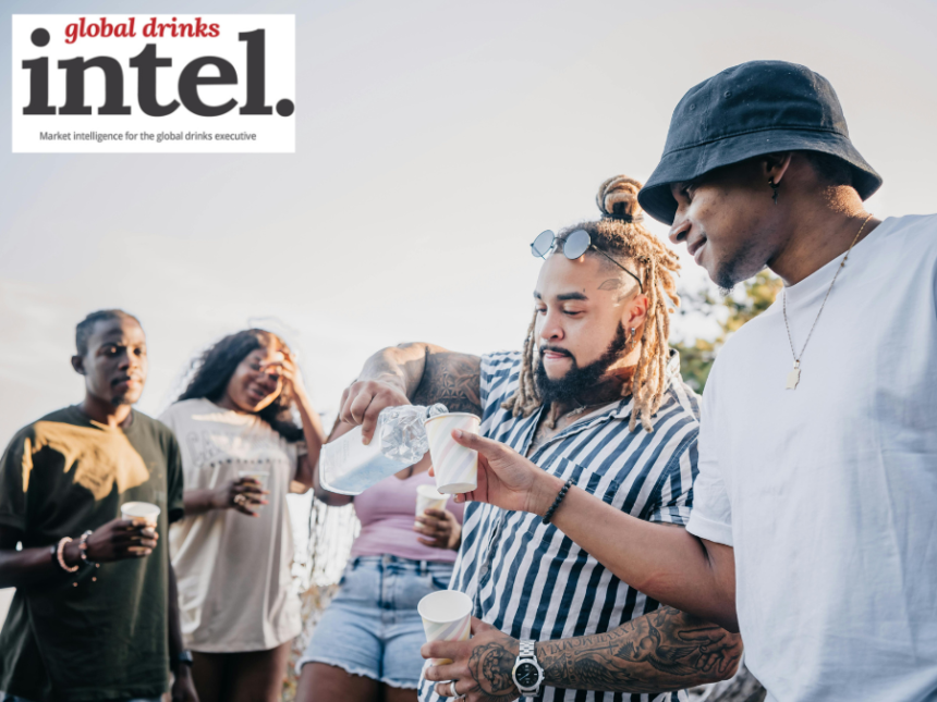 Adults sharing drinks outdoors