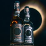 Bottle of Total Eclipse Bourbon next to Total Eclipse Moonshine