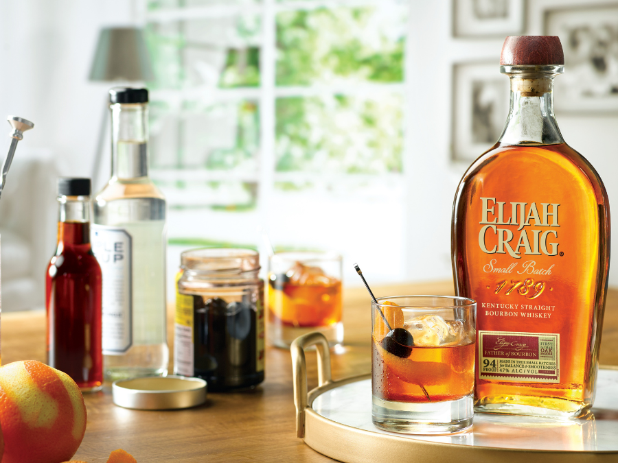 Bottle of Elijah Craig bourbon with an old fashioned serve