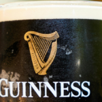 Close-up of Guinness logo on a branded glass
