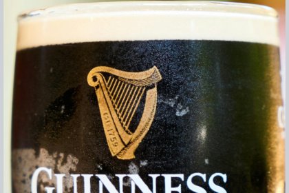 Close-up of Guinness logo on a branded glass