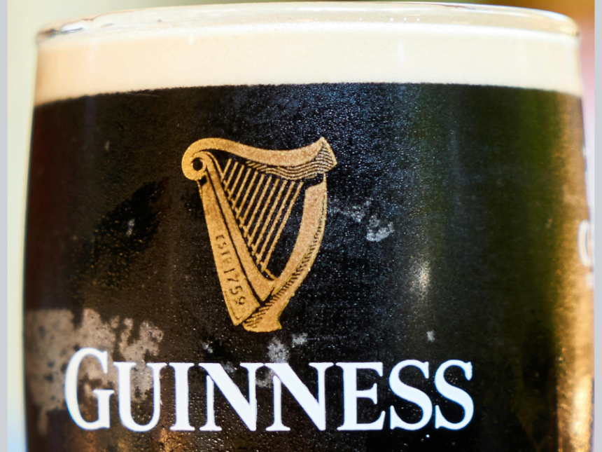 Close-up of Guinness logo on a branded glass