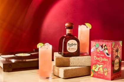 Bottle of and box for Don Julio tequila next to a record player