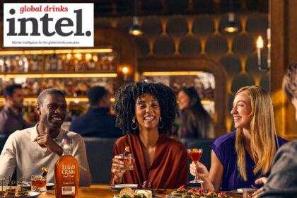 Drinkers sitting at a table with a bottle of Elijah Craig American whiskey