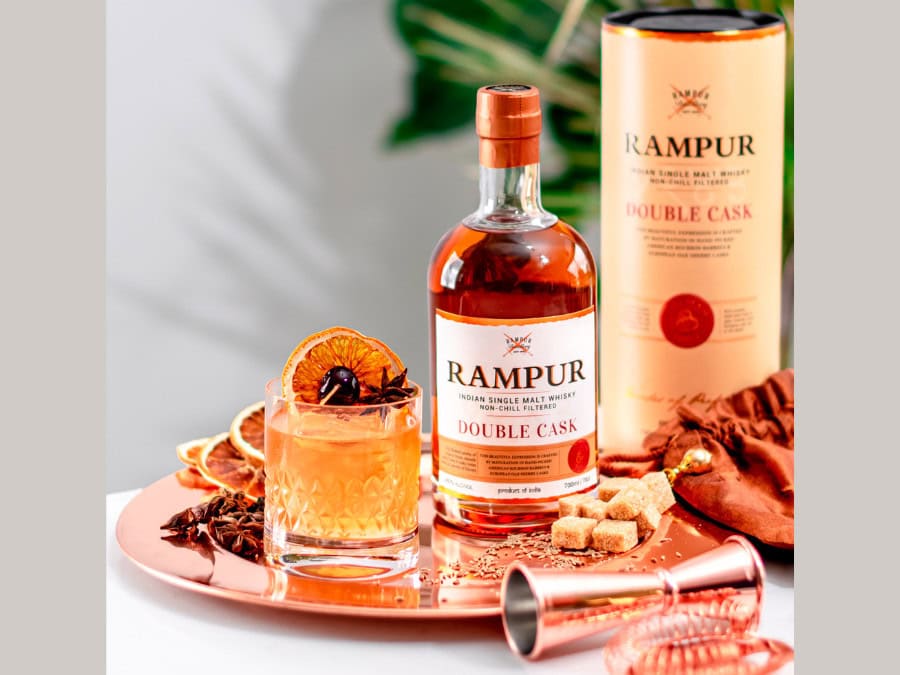 Bottle of and box for Rampur Double Cask with a cocktail serve
