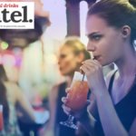 A woman enjoying a drink in a bar