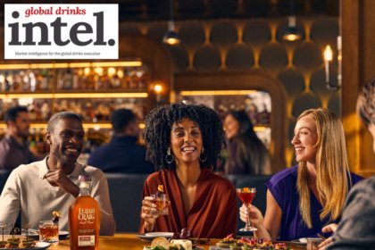 Drinkers sitting at a table with a bottle of Elijah Craig American whiskey