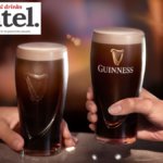 Two pints of Guinness on a bar