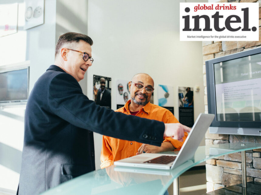 Two executives looking at a laptop screen