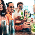 Drinkers raising glasses in a US bar