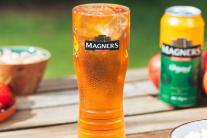 A branded glass and can of Magners