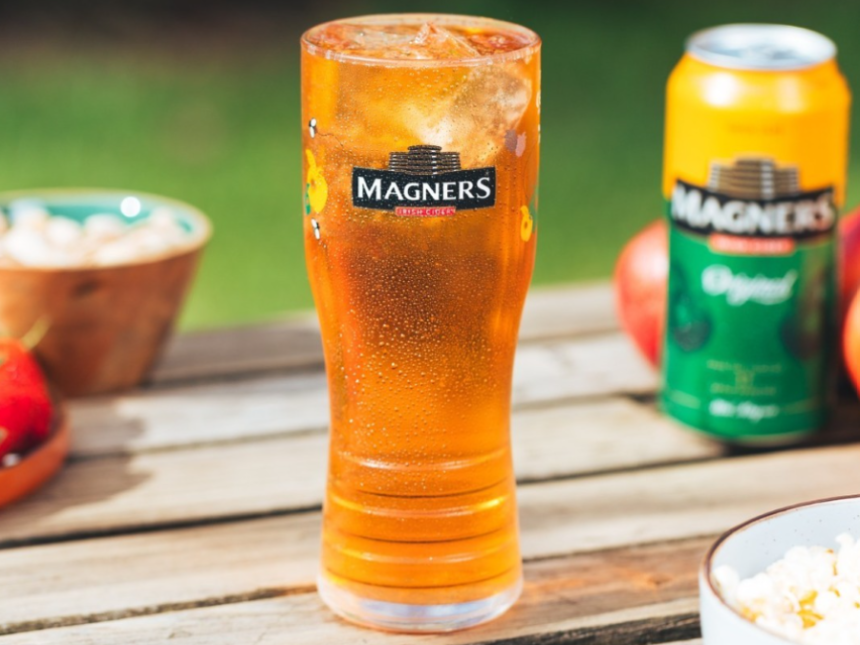A branded glass and can of Magners