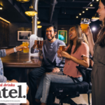 Four drinkers sitting at a bar
