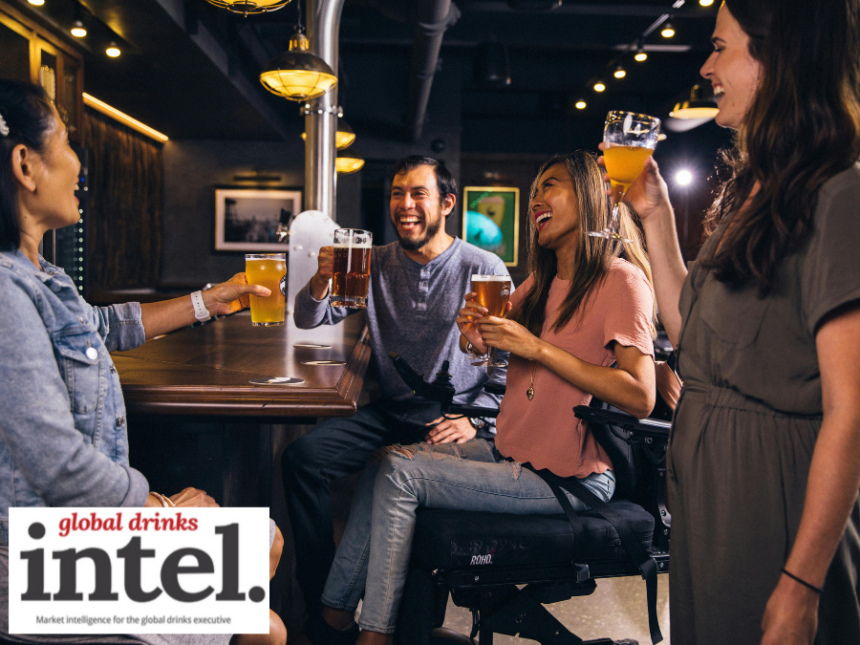 Four drinkers sitting at a bar