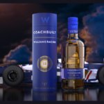 Bottle of and box for Coachbuilt 18-Year-Old Blended Scotch Whisky in front of a Williams F1 race car
