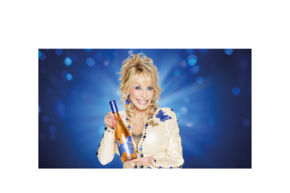 Dolly Parton holding a bottle of her branded wine