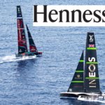 Two sailing boats competiting in the America's Cup and the Hennessy cognac logo