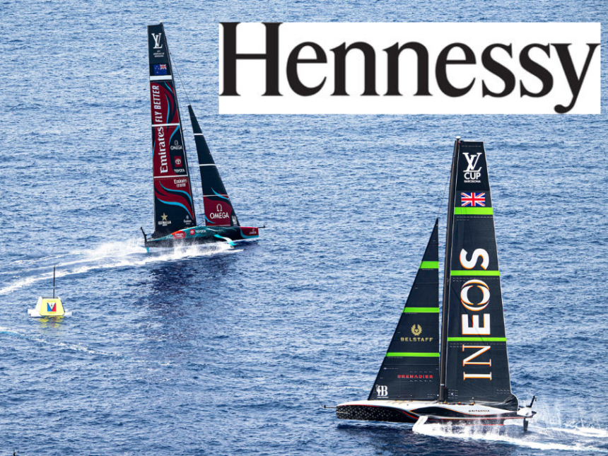 Two sailing boats competiting in the America's Cup and the Hennessy cognac logo