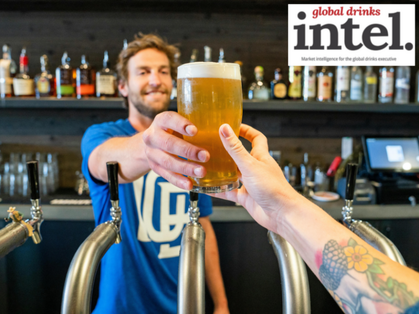 Bartender handing a drinker a full beer in a bar