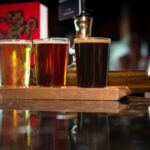 Three pints of beer on a bar