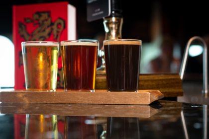 Three pints of beer on a bar