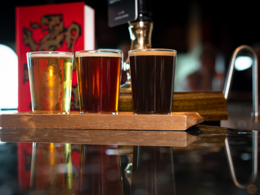 Three pints of beer on a bar