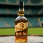 Buffalo Trace bottle with a rugby stadium backdrop