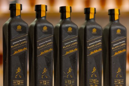 Line of five paper-based bottles of Johnnie Walker