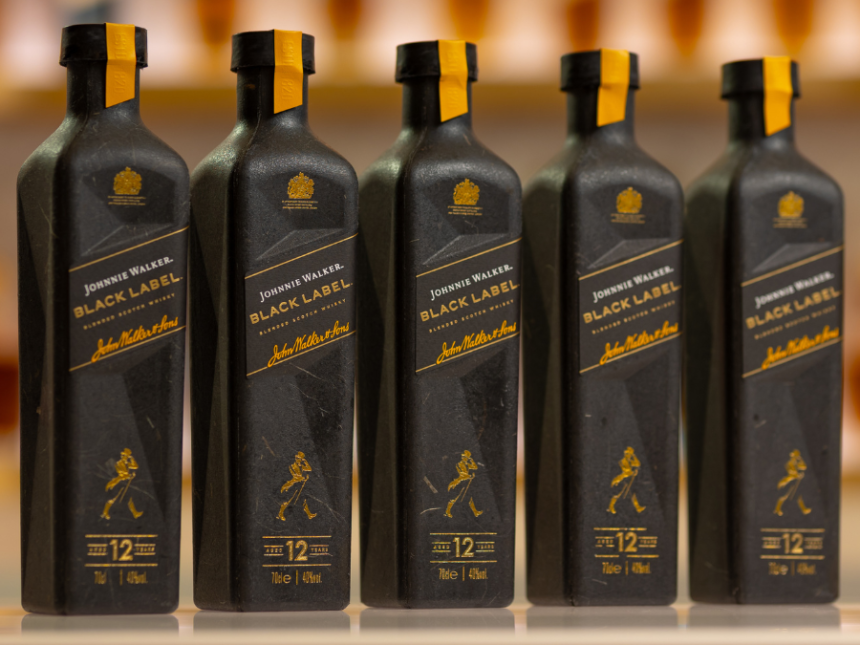 Line of five paper-based bottles of Johnnie Walker