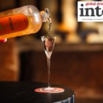 Bottle of Renais gin being poured into an elegant shot glass