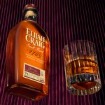 Bottle of Elijah Craig American whiskey with an old fashioned cocktail serve