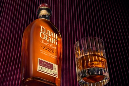 Bottle of Elijah Craig American whiskey with an old fashioned cocktail serve