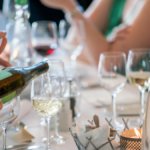 Wine being poured into a glass on a table