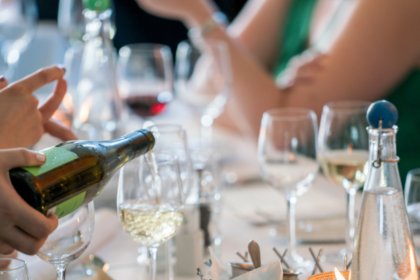 Wine being poured into a glass on a table