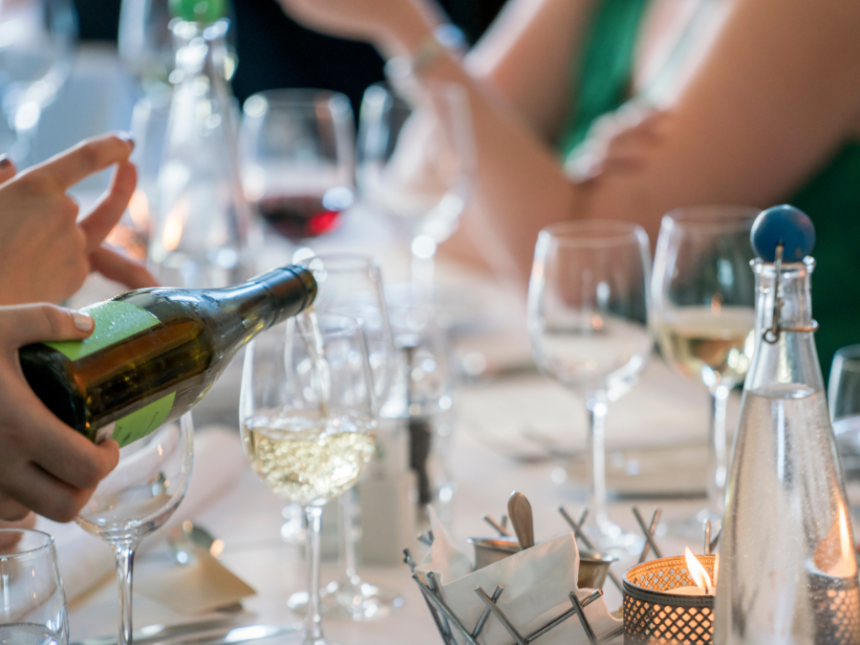 Wine being poured into a glass on a table