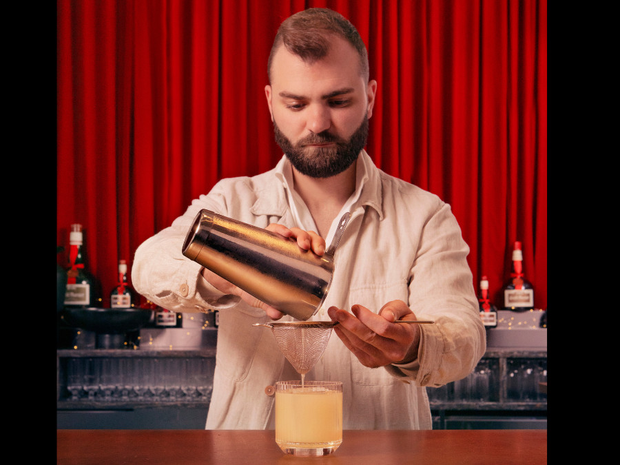 Hugo Togni preparing a cocktail featuring Grand Marnier