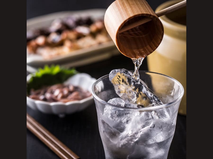 A sake serving being poured into a glass