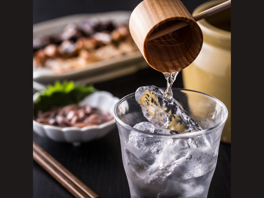 A sake serving being poured into a glass