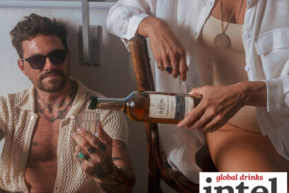 A man being poured a drink from a bottle of Ilegal mezcal