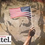 American flag against backdrop of mural of Donald Trump